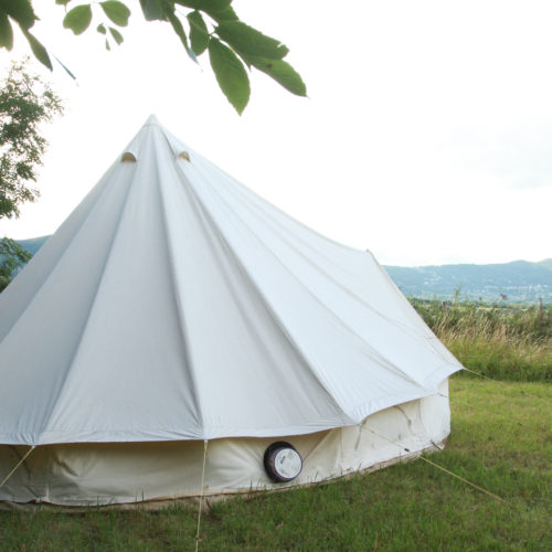 A white canvas bell tent looking out over the Malvern hills