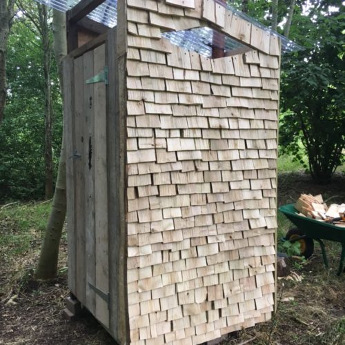Shingle clad compost loo in the woods