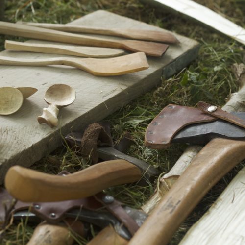 Four axes and a selection of spoons close-up