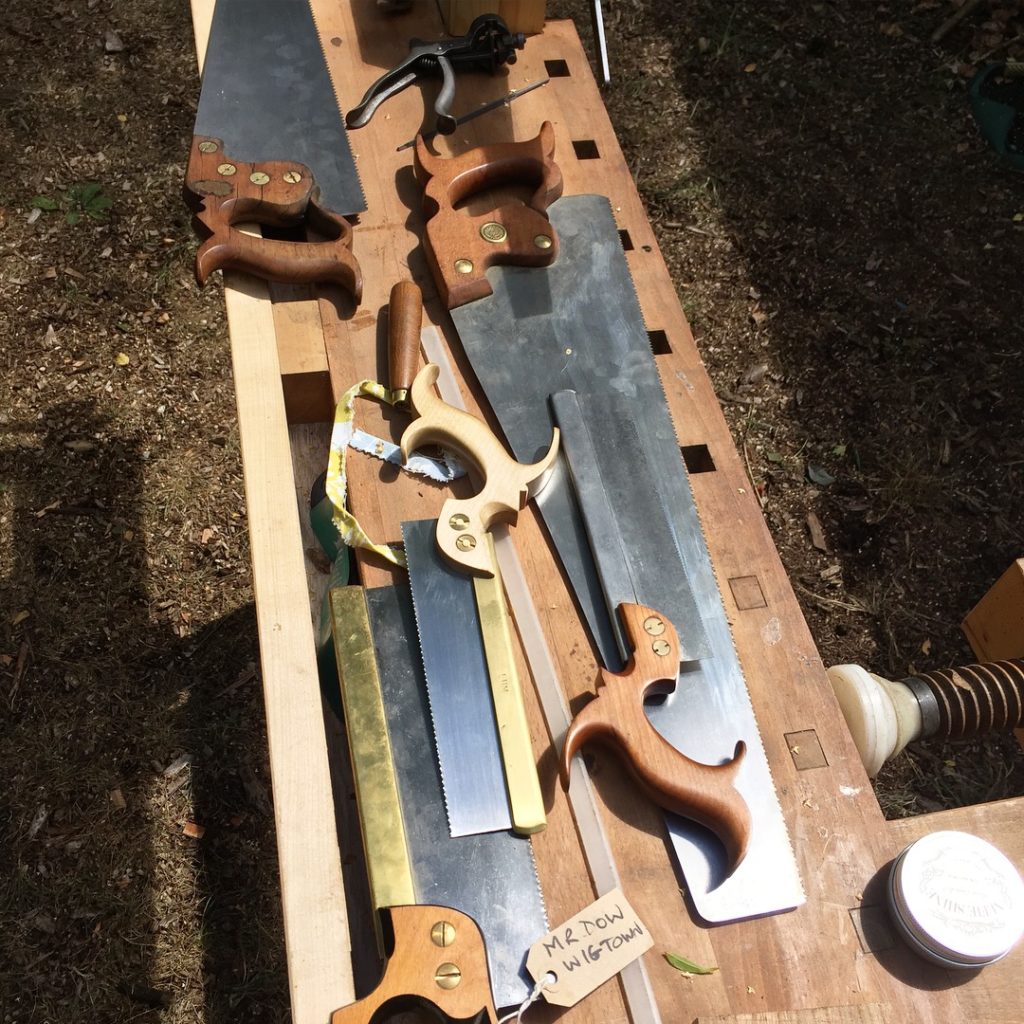 saws laid out on a bench