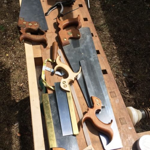 saws laid out on a bench